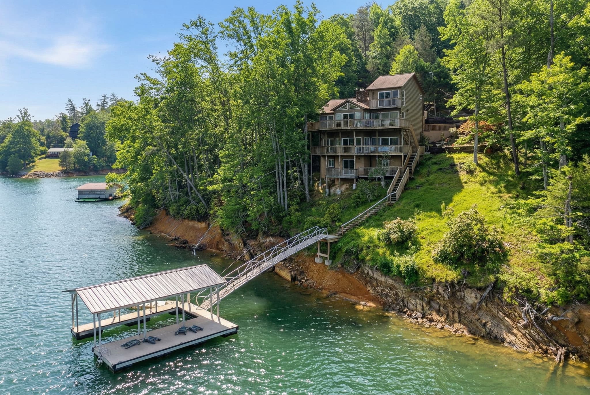 Aerial view of the house, the dock and the shoreline.